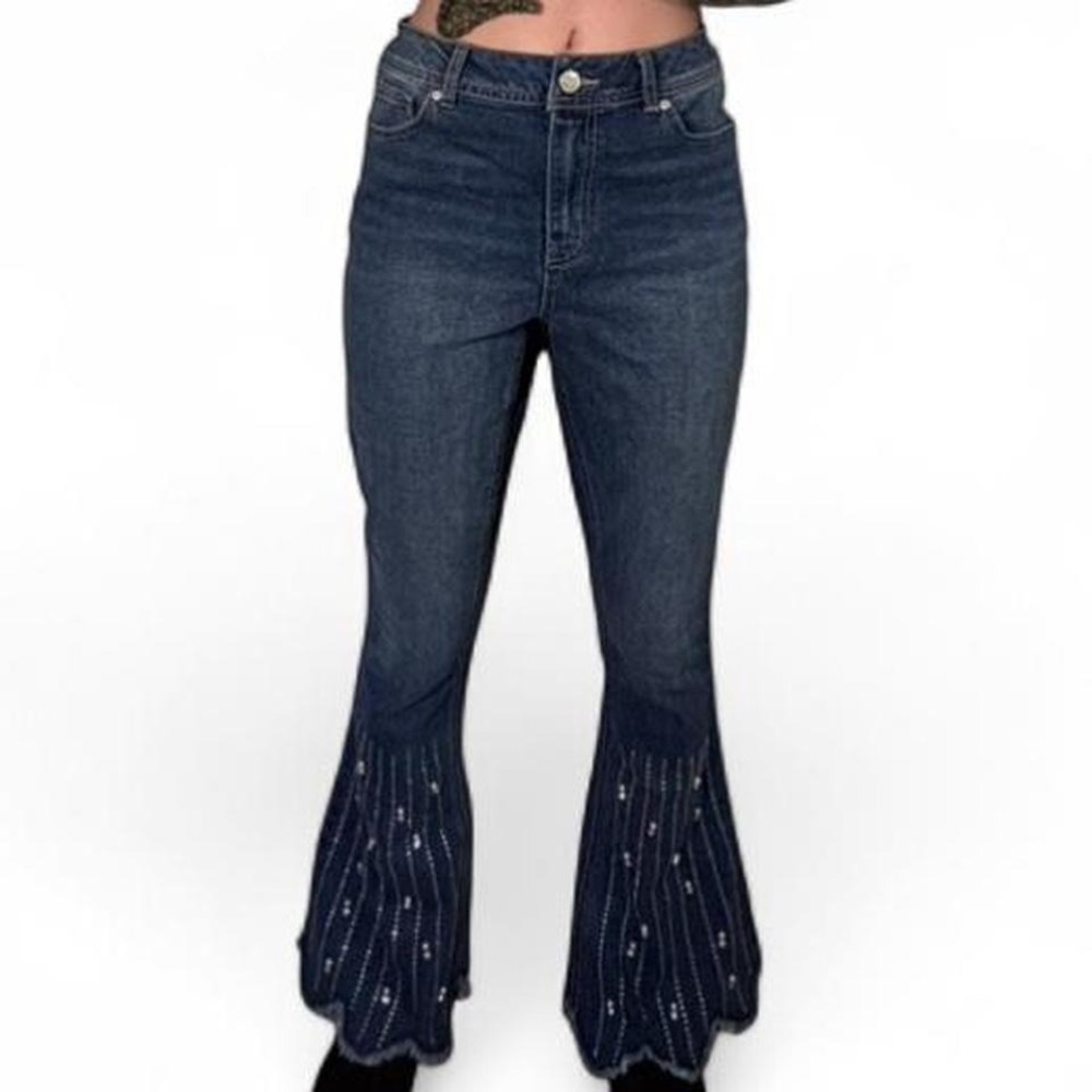 Dark wash denim jeans with frayed hem and beaded details